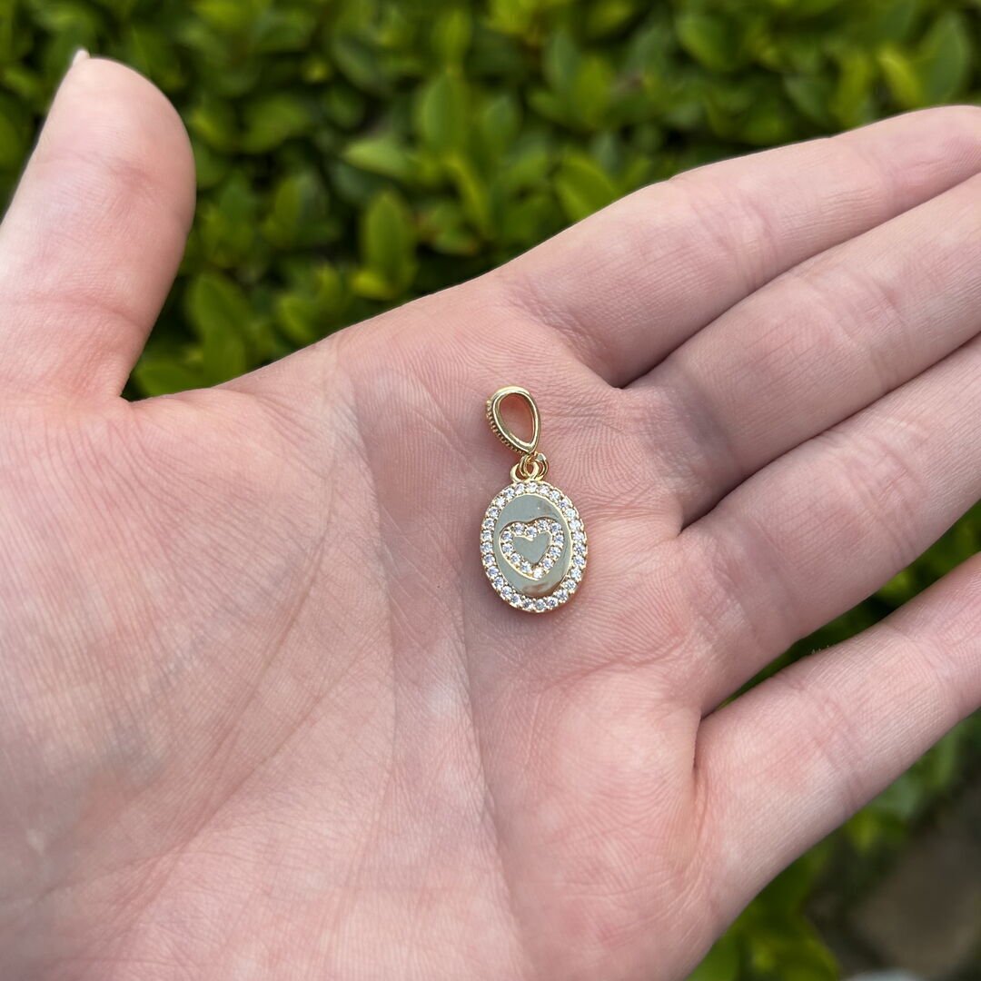 Pingente de Coração Oval Cravejado em Volta Cristal Dourado